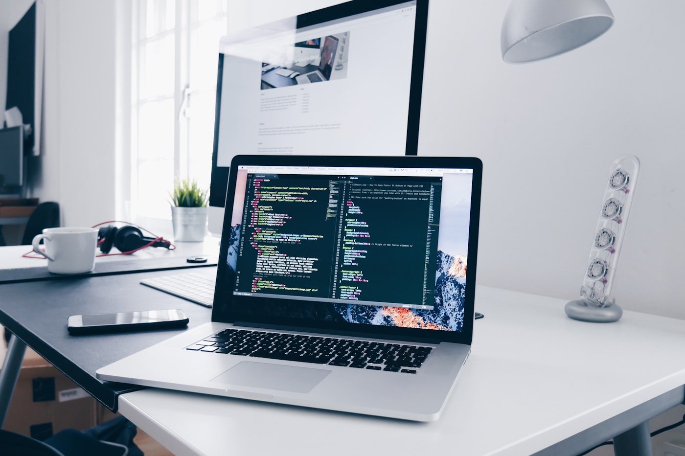 Developer working on website design on a MacBook
